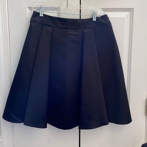 Armani Collection black skirt with soft pleats size 8 falls above the knee.